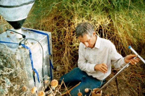 Checking soil moisture next to a device that measures carbon dioxide released by soils, Biosphere 2, 1991-1993.
